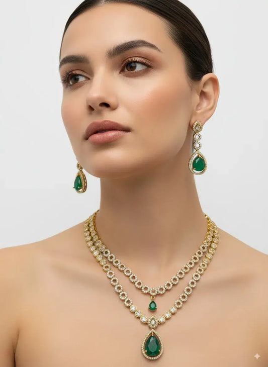 Woman wearing a green and gold necklace and earrings on a plain background