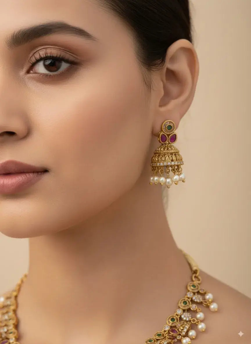 elegant model wearing floral cz pearl necklace set with multicolor stones & earrings featuring pearl danglers.