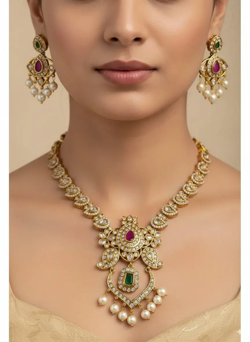 Royal Kundan Pearl Necklace Set with Multicolor Stones & Earrings worn by model, featuring intricate designs and pearl drops.