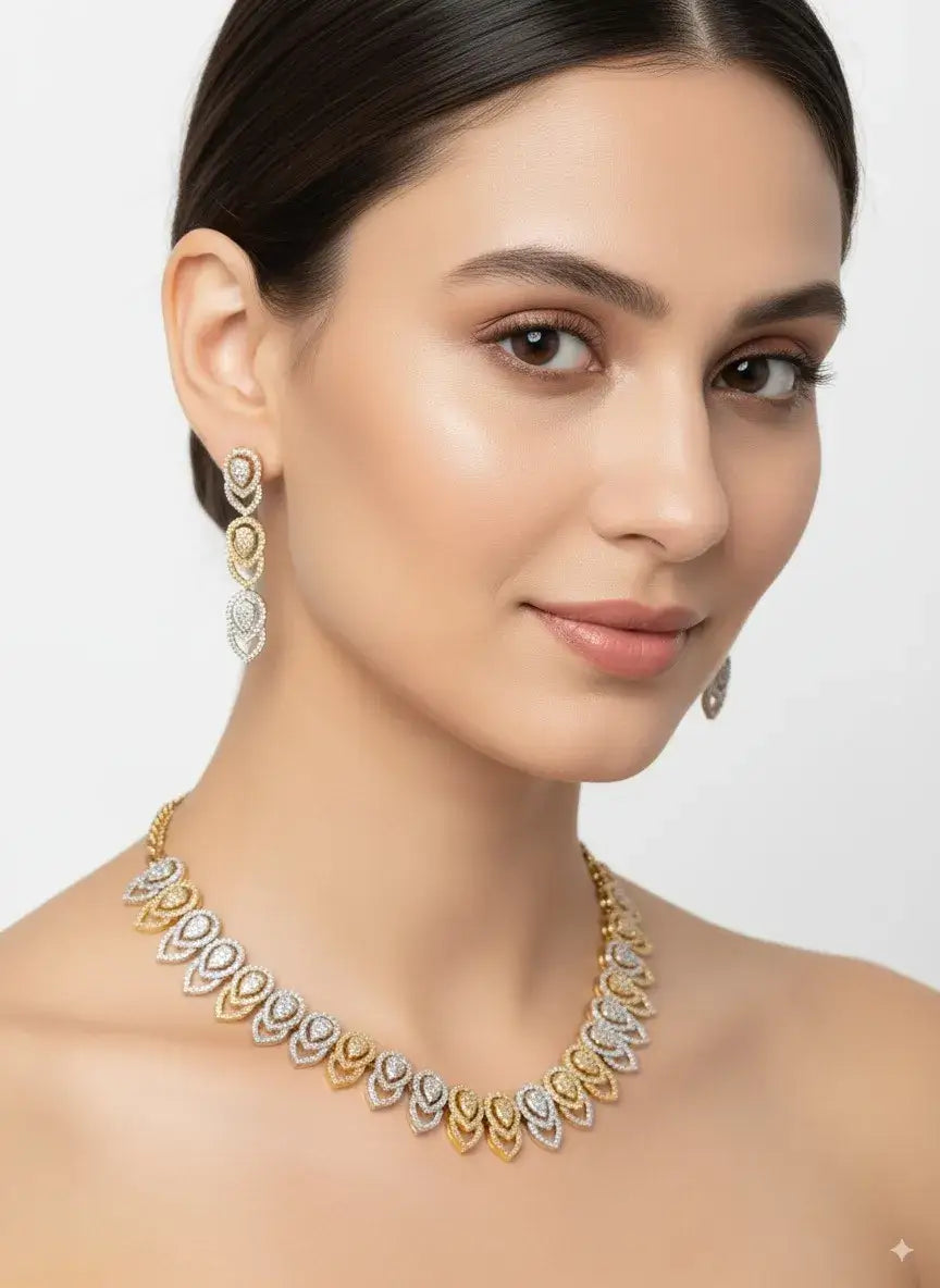dual tone cz necklace set with matching earrings displayed on a model, featuring golden and silver-toned teardrop motifs.