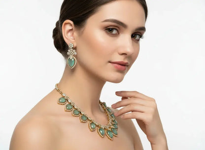 Pastel Green CZ Necklace Set with Earrings showcased on a model, featuring delicate teardrop stones and floral-drop earrings.