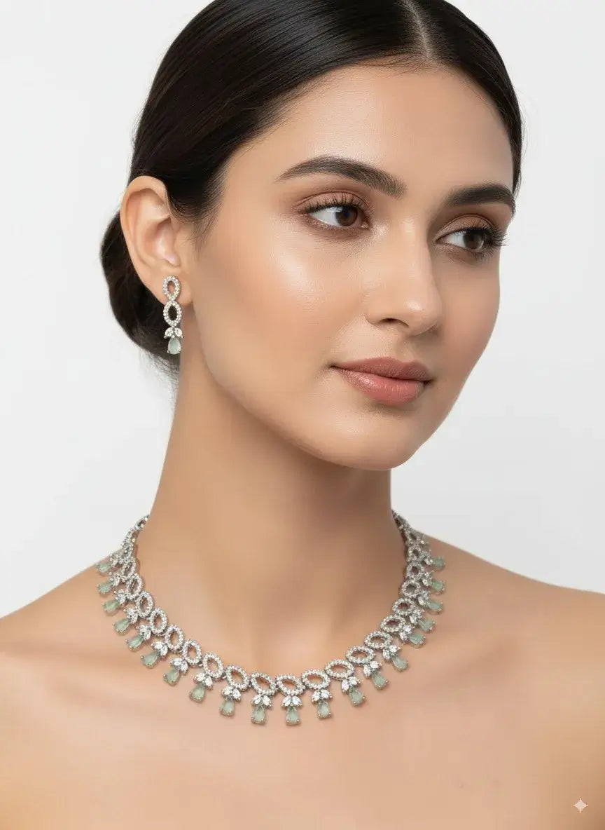 pastel green silver cz necklace set with earrings worn by a model, featuring teardrop stones and sparkling diamonds.