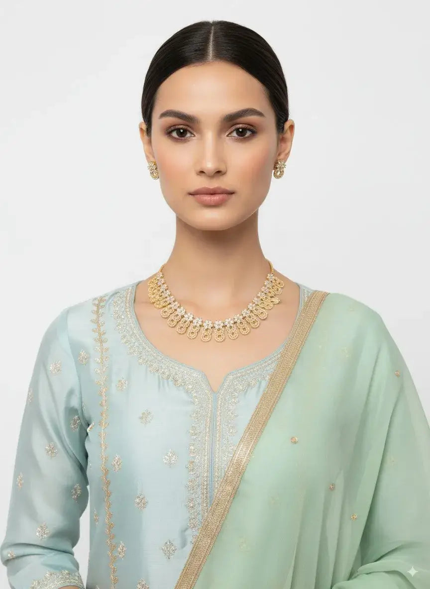 golden circular cz necklace set with matching earrings showcased on a model in traditional attire.