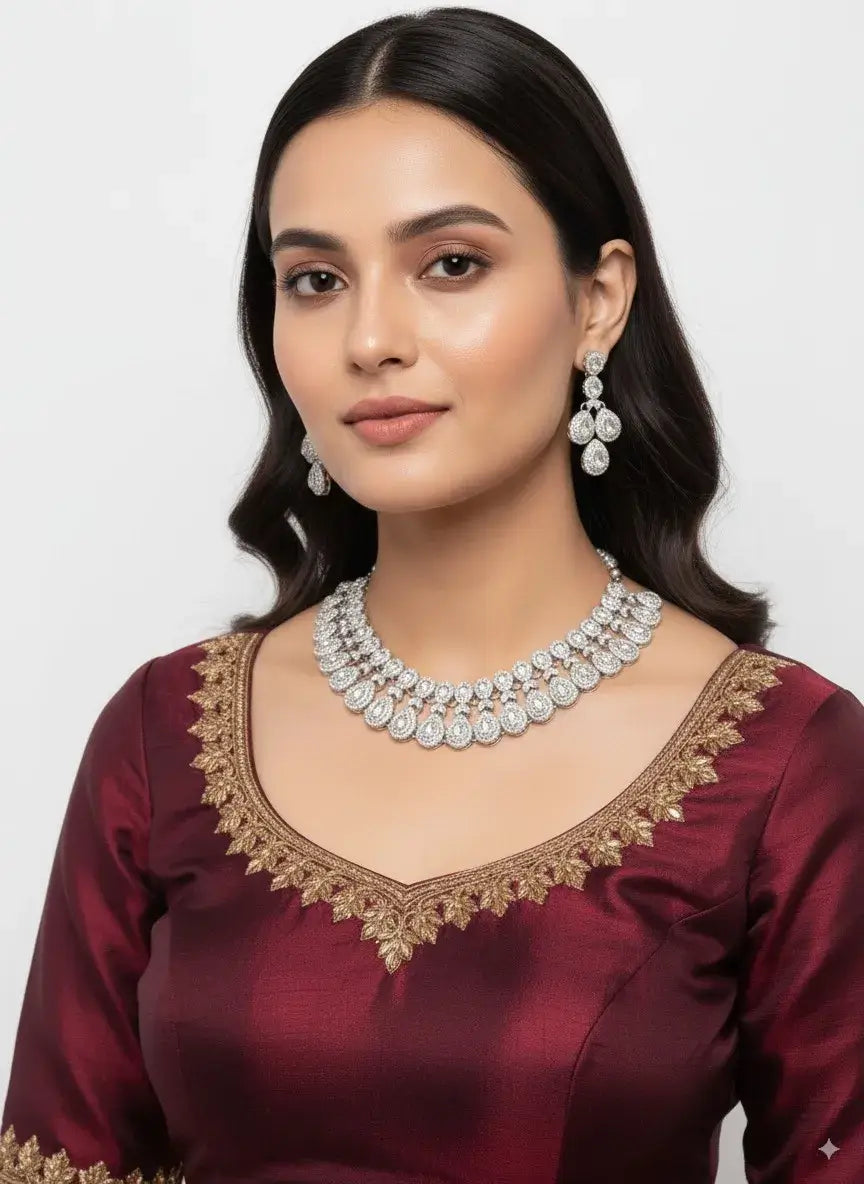 heavy bridal cz diamond choker necklace set with long earrings worn by a model in a maroon outfit.