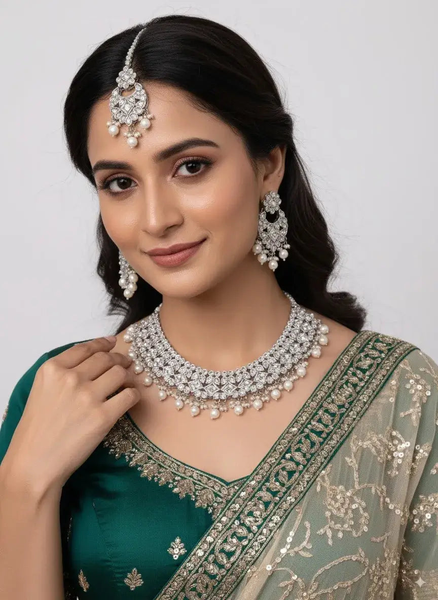 bridal cz diamond choker necklace set with pearls & maang tikka worn by a model with elegant outfit and jewelry.