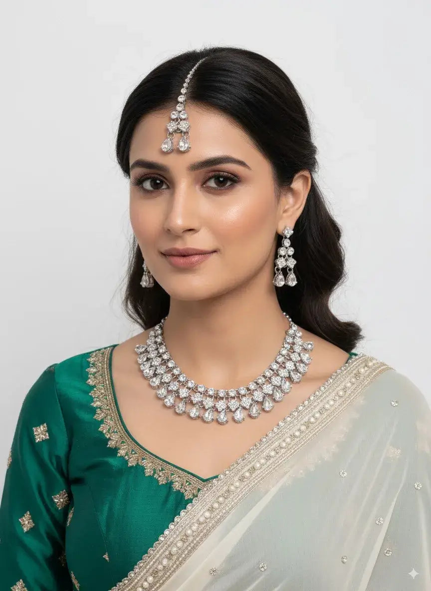 bridal diamond look cz necklace set with earrings & maang tikka worn by model showcasing bridal jewelry.