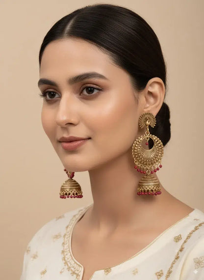 Gold Plated Jhumka Earrings with Red Beads | Ethnic Indian Jewelry for Women worn by a model in traditional attire.