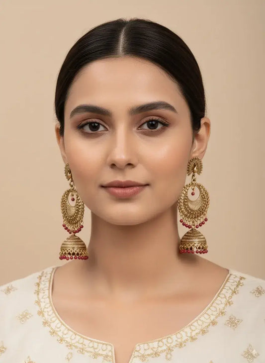 Gold Plated Jhumka Earrings with Red Beads | Ethnic Indian Jewelry for Women, worn by a model, showcasing traditional style.
