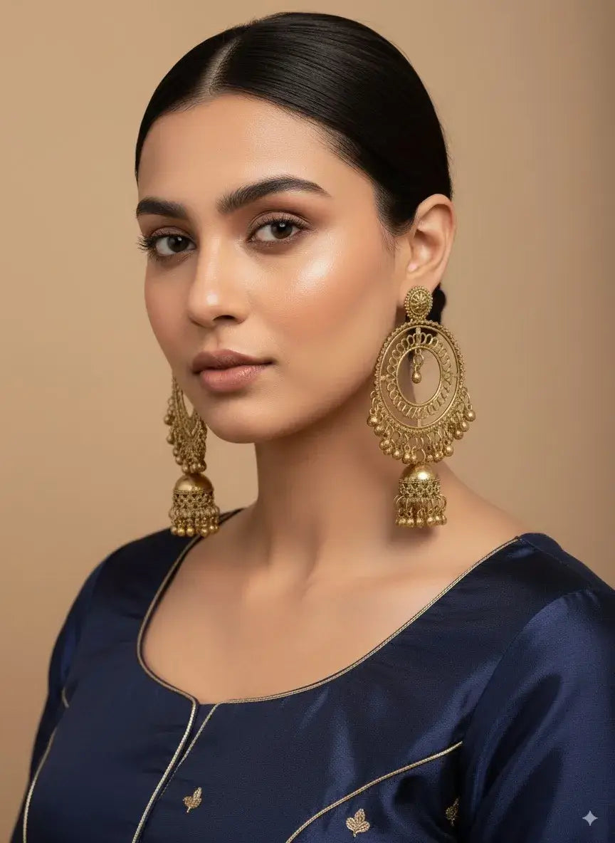 gold plated big round hoop jhumka earrings for women | bridal & party wear showcased on a model.