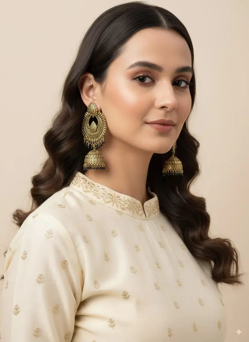Gold Plated Antique Jhumka Earrings for Women | Traditional Ethnic Jewelry worn by a woman in traditional attire.