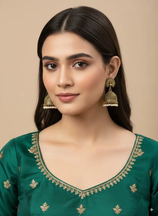 Antique Gold Peacock Jhumka Earrings with Pearl Drops – Traditional Jewellery showcased on model.