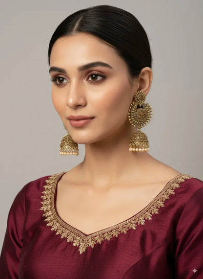 Antique Gold Temple Jhumka Earrings with Pearl Drops – Bridal & Festive Jewellery worn by a model in a maroon outfit.