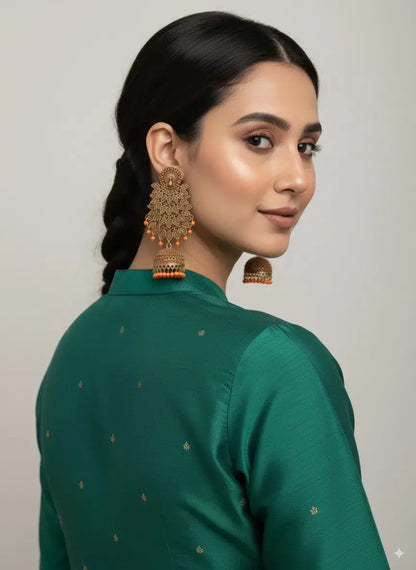 Gold Plated Long Jhumka Earrings with Orange Beads – Ethnic & Bridal Jewellery worn by model with green outfit.