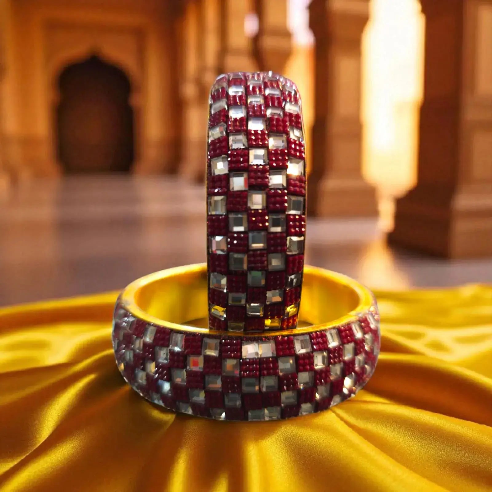 Red Checkered Stone Work Designer Bangles on a golden fabric, showcasing a blend of red and silver stones for partywear.