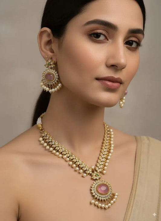 Pink Stone Pearl Kundan Necklace Set with Earrings worn by a woman, showcasing intricate designs and pearl detailing.