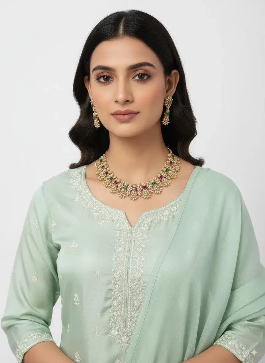 multicolor cz floral necklace set with earrings worn by a model in a mint green outfit.