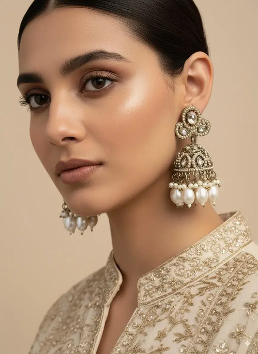 Antique Gold Plated Jhumka Earrings with Pearls showcased on a model wearing traditional ethnic attire.