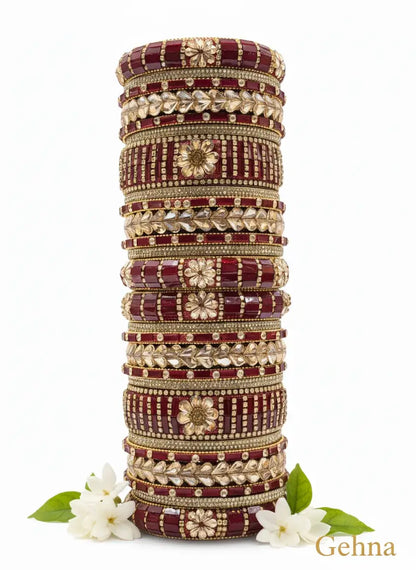Dark Red Gold Bridal Bangle Set – 26 Piece Kundan & Stone Work displayed with floral accents.