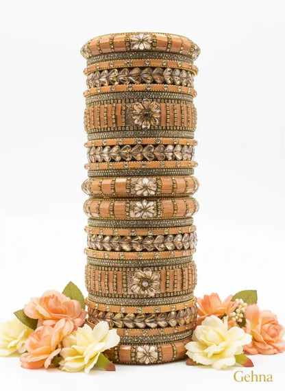 Peach-Gold Bridal Bangle Set – 26 Pieces Kundan & Stone Work by Gehna displayed with floral accents.