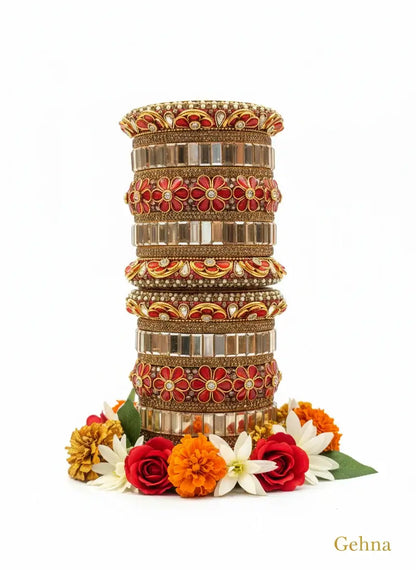 Red & Gold Bridal Floral Bangles – Premium Ethnic Jewellery Set displayed artistically with flowers.